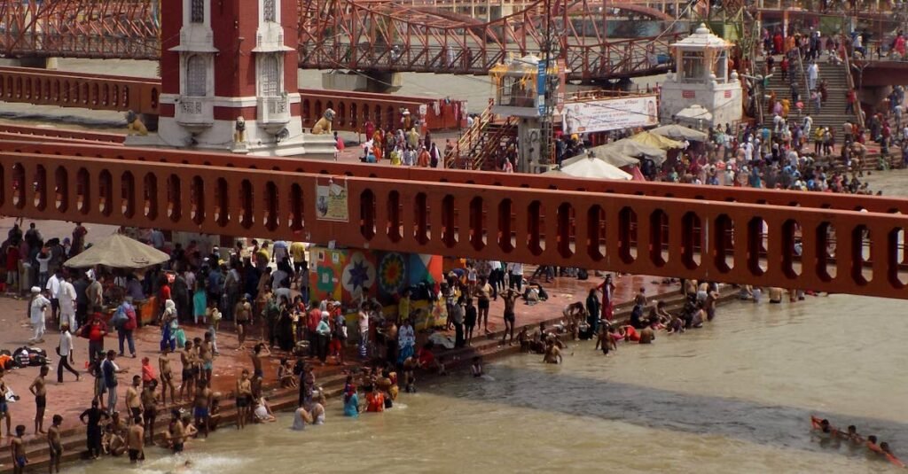 A vibrant scene of pilgrims bathing at the sacred Har Ki Pauri in Haridwar, India.